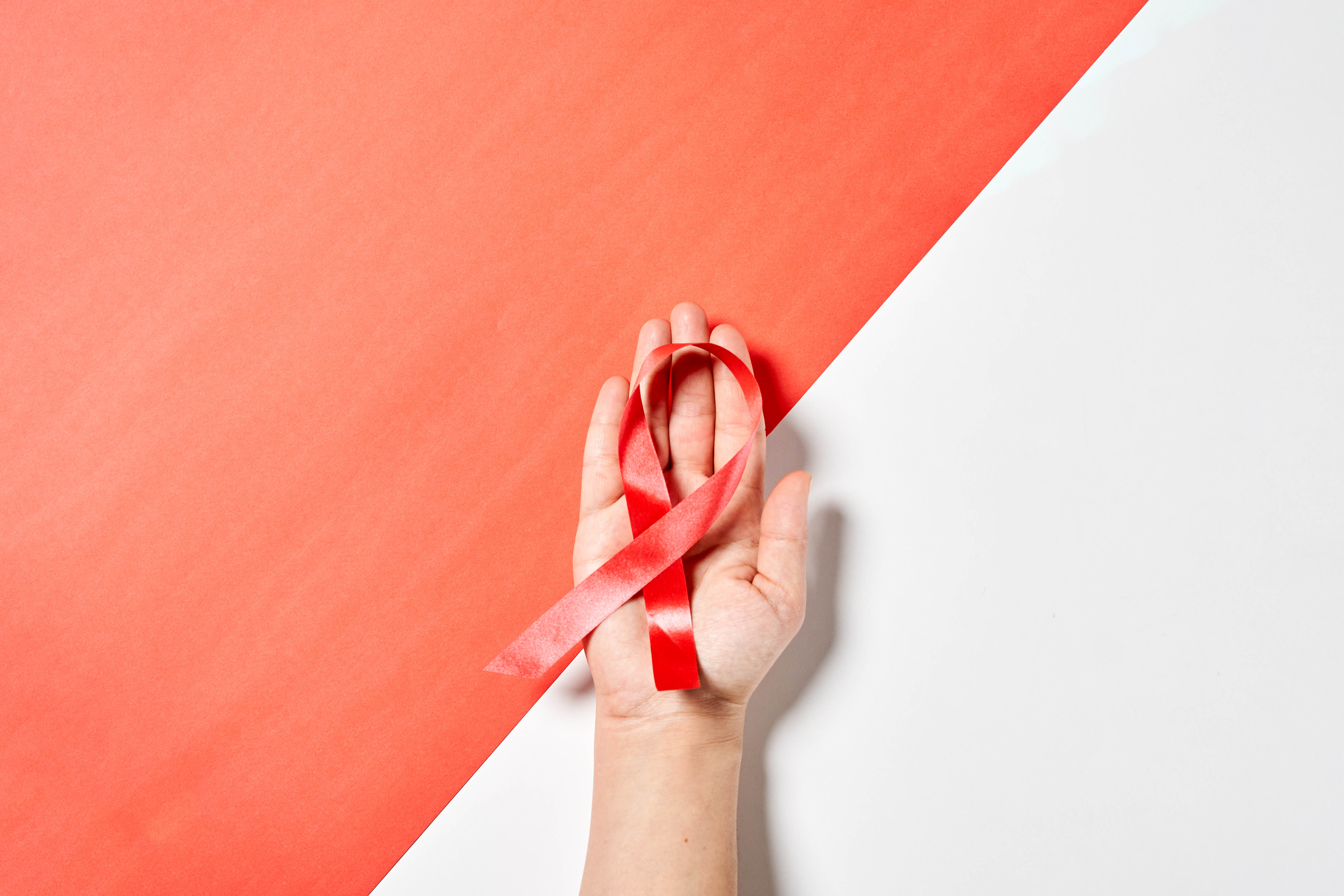 Woman holds cancer awareness ribbon