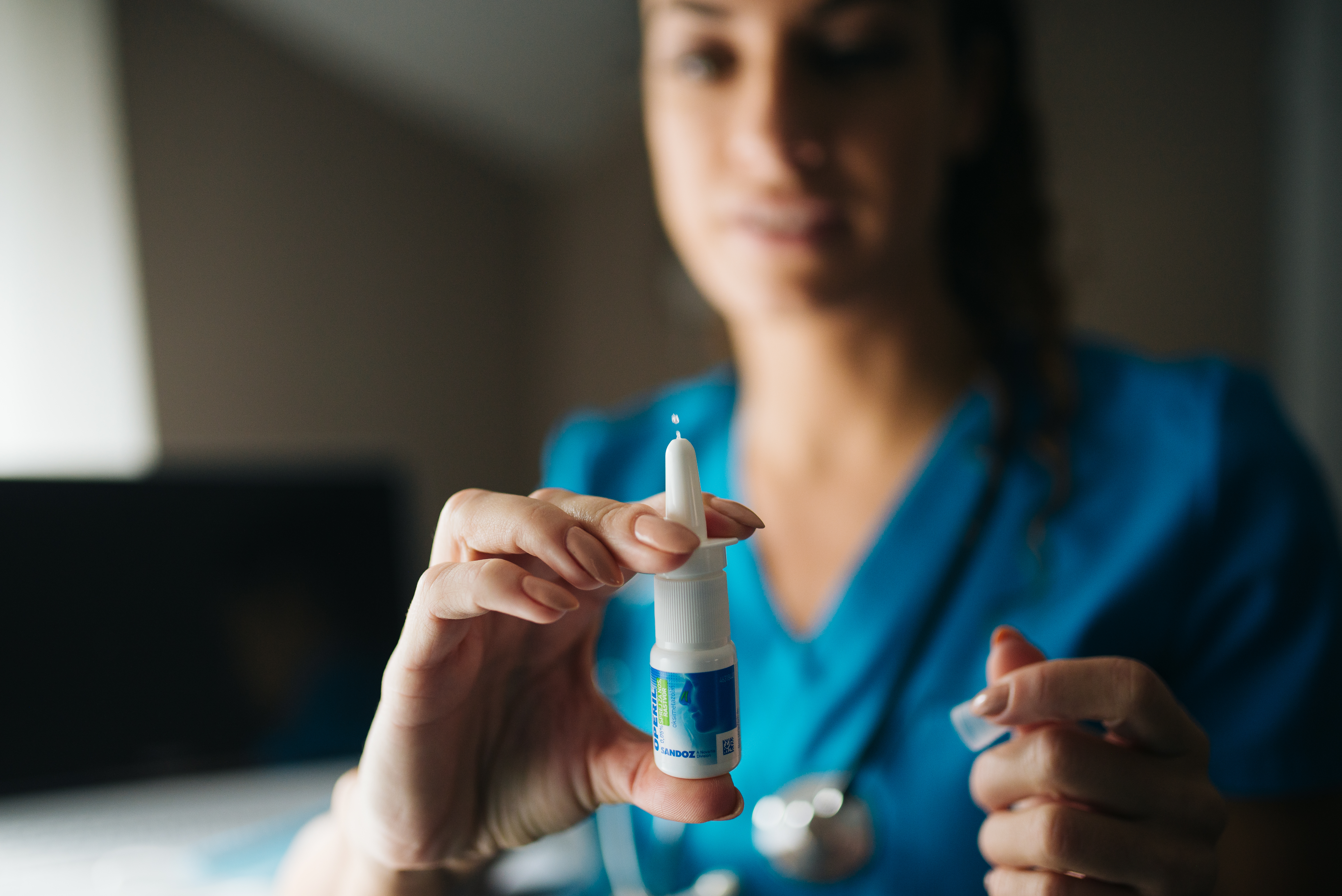 Female doctor holding nasal spray closeup